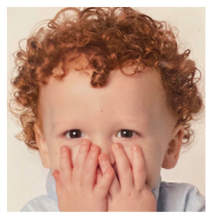 A young child with red hair and a blue shirt covering their face. AI generated content