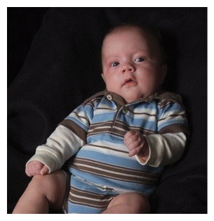 A baby wearing a striped shirt is sitting on a black surface. AI generated content