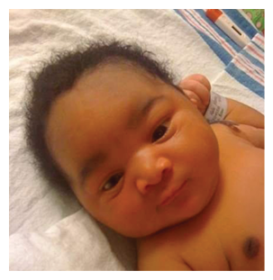 A baby with dark hair and dark eyes is lying on a white sheet. AI generated content