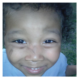 A young boy with a baseball shirt on, smiling and showing his teeth. AI generated content