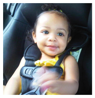 A baby girl is sitting in a car seat, smiling and holding a toy. AI generated content