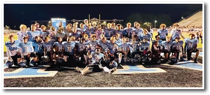 A football team posing for a picture on the field. AI generated content