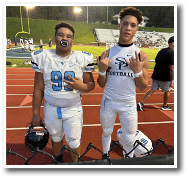 Two football players wearing white uniforms and holding footballs. AI generated content
