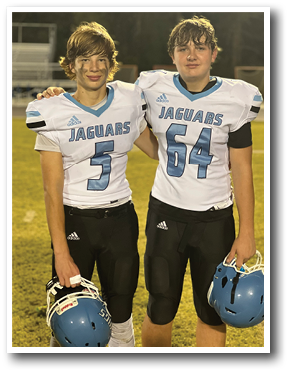 Two football players wearing white and blue uniforms with the number 54 and 54 on their jerseys. AI generated content
