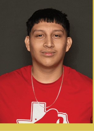 A young man wearing a white and black jersey with the number 14 on it. Description generated by AI