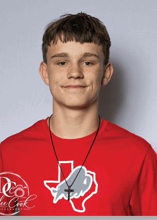 A young man wearing a white and black jersey with the number 14 on it. Description generated by AI