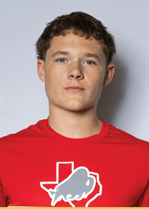 A young man wearing a white and black jersey with the number 14 on it. Description generated by AI