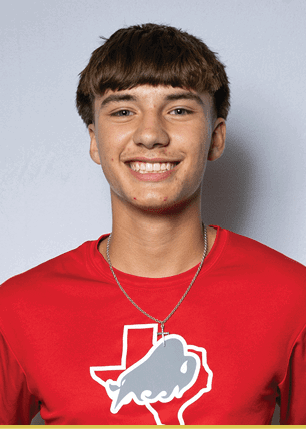 A young man wearing a white and black jersey with the number 14 on it. Description generated by AI