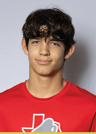 A young man wearing a white and black jersey with the number 14 on it. Description generated by AI