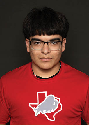 A young man wearing a white and black jersey with the number 14 on it. Description generated by AI