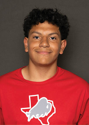 A young man wearing a white and black jersey with the number 14 on it. Description generated by AI