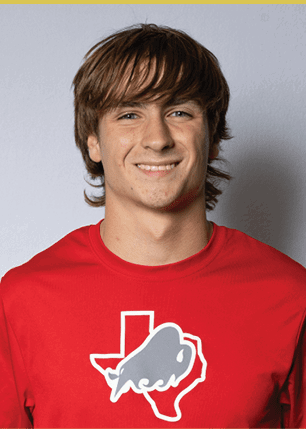 A young man wearing a white and black jersey with the number 14 on it. Description generated by AI