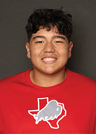 A young man wearing a white and black jersey with the number 14 on it. Description generated by AI