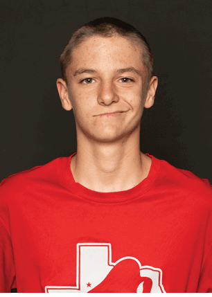 A young man wearing a white and black jersey with the number 14 on it. Description generated by AI