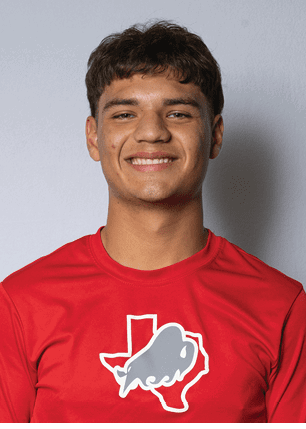 A young man wearing a white and black jersey with the number 14 on it. Description generated by AI