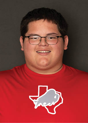 A young man wearing a white and black jersey with the number 14 on it. Description generated by AI