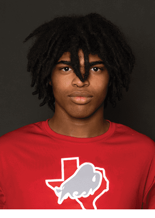 A young man wearing a white and black jersey with the number 14 on it. Description generated by AI