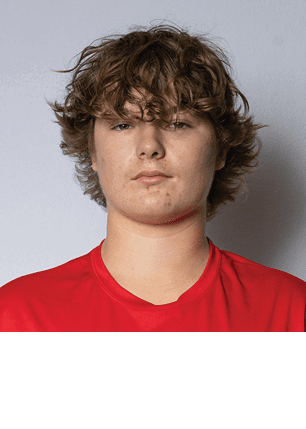 A young man wearing a white and black jersey with the number 14 on it. Description generated by AI