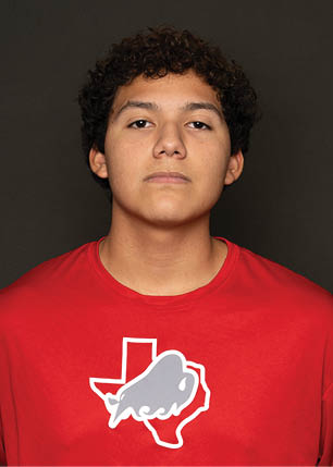 A young man wearing a white and black jersey with the number 14 on it. Description generated by AI