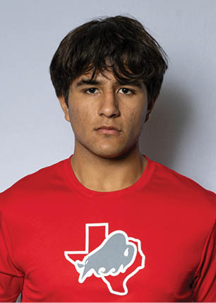 A young man wearing a white and black jersey with the number 14 on it. Description generated by AI