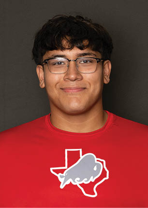 A young man wearing a white and black jersey with the number 14 on it. Description generated by AI
