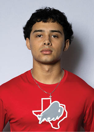 A young man wearing a white and black jersey with the number 14 on it. Description generated by AI