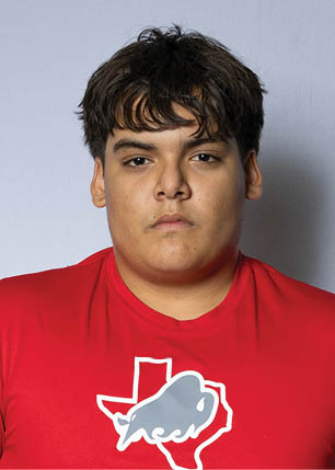 A young man wearing a white and black jersey with the number 14 on it. Description generated by AI