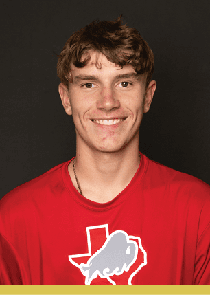 A young man wearing a white and black jersey with the number 14 on it. Description generated by AI