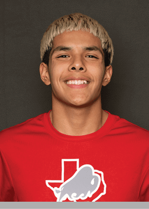 A young man wearing a white and black jersey with the number 14 on it. Description generated by AI
