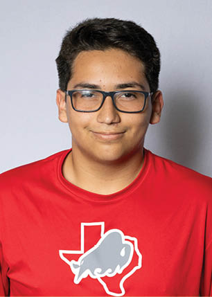 A young man wearing a white and black jersey with the number 14 on it. Description generated by AI