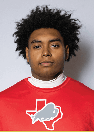 A young man wearing a white and black jersey with the number 14 on it. Description generated by AI
