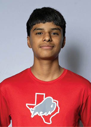 A young man wearing a white and black jersey with the number 14 on it. Description generated by AI