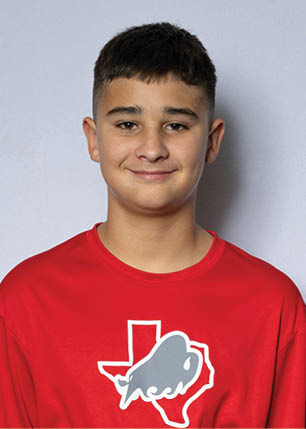 A young man wearing a white and black jersey with the number 14 on it. Description generated by AI