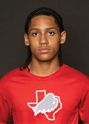 A young man wearing a white and black jersey with the number 14 on it. Description generated by AI