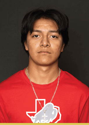 A young man wearing a white and black jersey with the number 14 on it. Description generated by AI