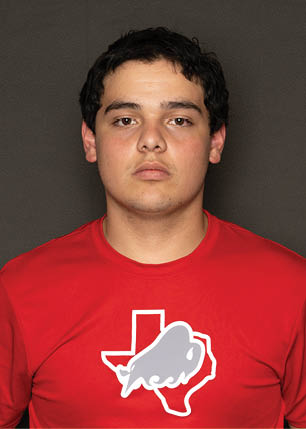 A young man wearing a white and black jersey with the number 14 on it. Description generated by AI
