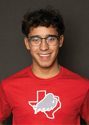A young man wearing a white and black jersey with the number 14 on it. Description generated by AI