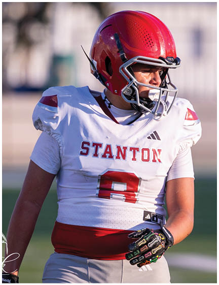 A football player wearing a blue jersey with the number 58 on it. Description generated by AI