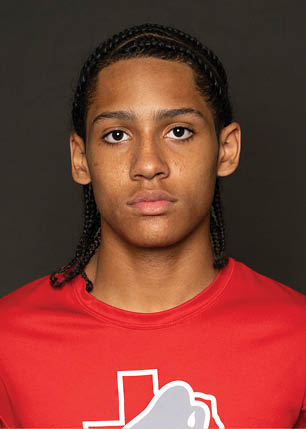 A young man wearing a white and black jersey with the number 14 on it. Description generated by AI