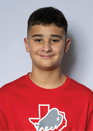 A young man wearing a white and black jersey with the number 14 on it. Description generated by AI