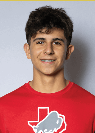A young man wearing a white and black jersey with the number 14 on it. Description generated by AI