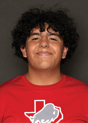 A young man wearing a white and black jersey with the number 14 on it. Description generated by AI