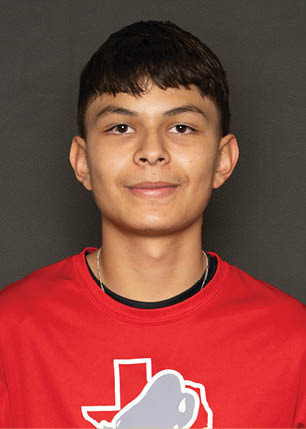 A young man wearing a white and black jersey with the number 14 on it. Description generated by AI