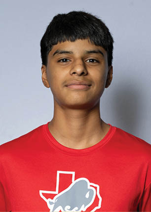 A young man wearing a white and black jersey with the number 14 on it. Description generated by AI