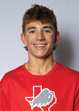 A young man wearing a white and black jersey with the number 14 on it. Description generated by AI