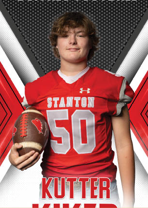 A young man wearing a white and black jersey with the number 14 on it. Description generated by AI