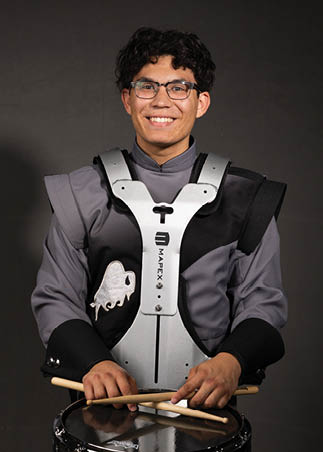 A young man wearing a white and black jersey with the number 14 on it. Description generated by AI