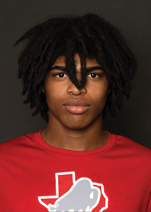 A young man wearing a white and black jersey with the number 14 on it. Description generated by AI