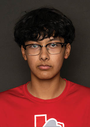 A young man wearing a white and black jersey with the number 14 on it. Description generated by AI