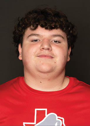 A young man wearing a white and black jersey with the number 14 on it. Description generated by AI